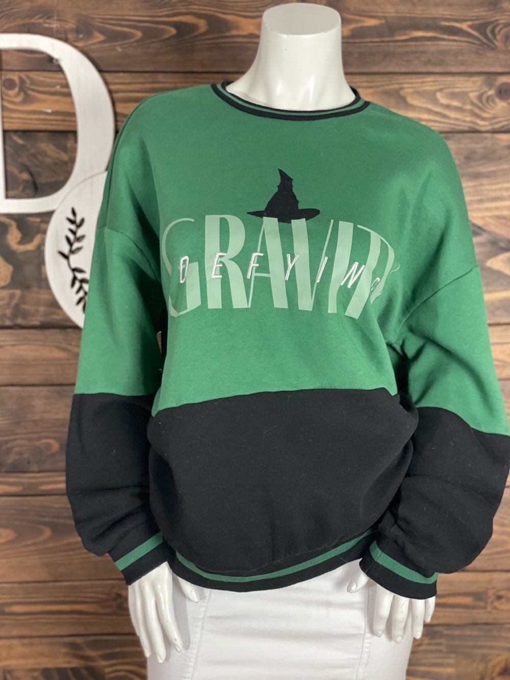 Wicked | Defying Gravity Color-block Green and Black Graphic Pullover Sweater